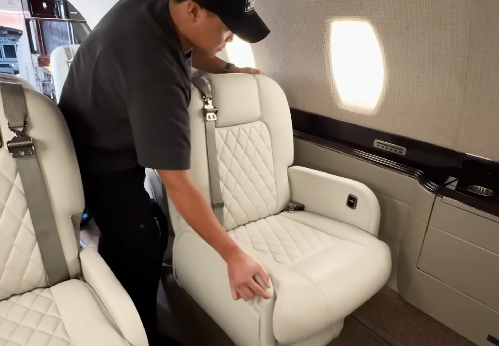 Technician preparing a private jet cabin seat between flights
